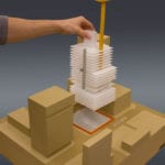 View of an engineering scale model with interchangable parts showing various stages of construction of a building deploying an integrated crane