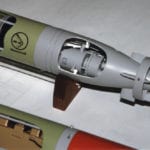 Detail view of Honeywell torpedo showing cutaway panels and hand-made brass screw