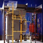 View of a detailed engineering scale model of an industrial process featuring color-coded piping systems