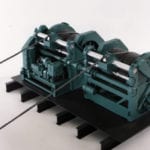 Full view of an engineering scale model of a ship winch with cables extended