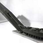 Three quarter view of an engineering scale model of a self-propelled tank-launched bridge showing bridge partially extended demonstrating the built-in articulation