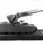 Three quarter view of an engineering scale model of a Paccar self-propelled remote gun on custom shipping case base
