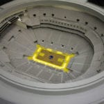 Interior view of the architectural scale model of Chase Center basketball arena, home of the Golden State Warriors, showing courtside seating section lighting features