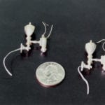 Detail view of a museum scale model of tiny lanterns created for the Rosalie Whyel Museum with a quarter coin for scale